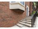 Brick home showcasing a side view of the entry stairs and landscaping at 1634 Ponce De Leon Ave # 107, Atlanta, GA 30307