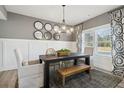 Stylish dining room with wood table, decorative mirrors, and large windows offering ample natural light at 306 Rodeo Dr, Auburn, GA 30102
