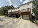 Rear exterior of townhouse-style homes, with attached garages and wood decks at 905 Park Ne Pl, Conyers, GA 30012