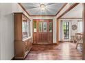 Welcoming foyer featuring hardwood floors, decorative ceiling, and a view into adjacent rooms at 110 The Farm Rd, Mcdonough, GA 30252