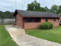 Charming single-story home featuring a brick facade, cozy porch, and well-maintained lawn at 4009 Ester Sw Dr, Atlanta, GA 30331