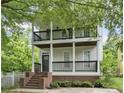 Charming two-story home featuring double balconies and brick-based front porch at 59 Stafford Nw St, Atlanta, GA 30314