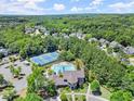 An aerial view shows community amenities featuring tennis courts and a swimming pool at 6084 Queens River Dr, Mableton, GA 30126