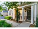 Welcoming front porch with elegant columns, manicured bushes and a covered entrance at 2623 Grapevine Cir # 602, Cumming, GA 30041