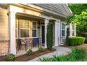 Inviting front porch with brick accents, white pillars, and a cozy seating area at 2623 Grapevine Cir # 602, Cumming, GA 30041