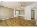 Open-concept living room with hardwood floors and plenty of natural light at 312 Burdock Trce, Woodstock, GA 30188