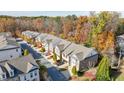 Aerial view of a residential neighborhood showcasing well-maintained townhomes and lush trees at 5260 Cresslyn Rdg, Alpharetta, GA 30005