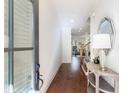 Inviting entryway with hardwood floors, a stylish console table, and a view into the living area at 5260 Cresslyn Rdg, Alpharetta, GA 30005