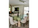 Elegant dining room with modern chandelier, glass table, and comfortable chairs at 1218 Matt Moore Ct, Lithia Springs, GA 30122