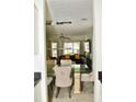 Stylish dining area with glass table, cozy chairs, and open view to the living room at 1218 Matt Moore Ct, Lithia Springs, GA 30122