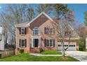 Charming two-story brick home with a well-manicured lawn and a two-car garage at 4271 Weston Sw Dr, Lilburn, GA 30047