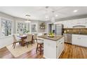 Eat-in kitchen featuring granite countertops, stainless steel appliances, and an island at 4271 Weston Sw Dr, Lilburn, GA 30047