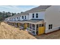 Exterior view of a row of modern townhomes with a covered and screened back porch at 1277 Fern Ridge Ct # 22, Norcross, GA 30093