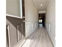Inviting foyer with light wood-look floors, wainscoting, and access to the main living areas at 1277 Fern Ridge Ct # 22, Norcross, GA 30093