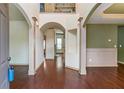 Elegant foyer with hardwood floors, arched doorways, and decorative columns at 1645 Colleens Cask Ter, Dacula, GA 30019
