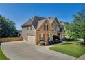 Beautiful brick two-story home with a well-manicured lawn and attached two car garage at 3641 Carriage Glen Way, Dacula, GA 30019