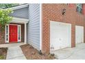 Attractive two-story home featuring a red door and brick and gray siding at 4795 Wilkins Station Dr, Decatur, GA 30035