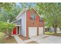 Beautiful two-story home with red brick, gray siding, and a bright red door at 4795 Wilkins Station Dr, Decatur, GA 30035