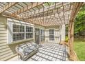 Cozy covered patio with a wicker couch, perfect for outdoor relaxation at 1465 Laleiah Dr, Cumming, GA 30041