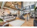 Open-concept living area with modern staircase, kitchen, and exposed ductwork at 640 Glen Iris Ne Dr # 609, Atlanta, GA 30308