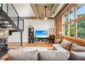 Comfortable living room featuring brick accent wall, hardwood floors and a large window at 640 Glen Iris Ne Dr # 609, Atlanta, GA 30308