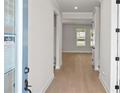 Bright entryway features light hardwood floors, gray walls, white trim, and an open floor plan at 6944 Melody Ridge Rd, Buford, GA 30518