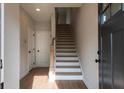 Light-filled foyer with hardwood flooring and a staircase leading to the upper level at 4810 Floydwood Ln, Mableton, GA 30126