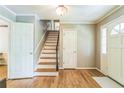 Bright foyer with hardwood floors, staircase, neutral paint, and white trim and doors at 7310 Ne Wynhill Ne Dr, Atlanta, GA 30328