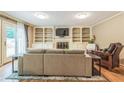 Cozy living room with built-in bookshelves surrounding a fireplace and french doors to the backyard at 7310 Ne Wynhill Ne Dr, Atlanta, GA 30328