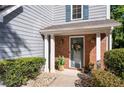 Inviting front entrance featuring a brick facade, charming columns, and a welcoming floral wreath at 3253 Strathmore Dr, Duluth, GA 30096