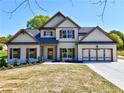 Beautiful two-story home with neutral paint, stylish shutters, and a well-manicured lawn at 3132 Rosebud Rd, Loganville, GA 30052