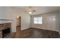 Bright living room with hardwood floors, fireplace, and a view of other rooms at 39 Spring Leaf Pl, Dallas, GA 30157