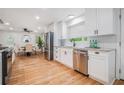 Modern kitchen boasts white cabinets, stainless steel appliances, and an open layout perfect for entertaining at 4807 Kenilworth Dr, Stone Mountain, GA 30083