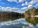 Scenic lake view with reflections of clouds and trees, offering a serene and natural setting at 4807 Kenilworth Dr, Stone Mountain, GA 30083