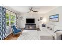 Inviting living room featuring wood floors, white sofa, a fireplace and large windows that provide ample light at 2779 Fairlee Dr, Decatur, GA 30032