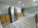 Open kitchen design showcasing stainless steel refrigerator, wood cabinets, and stylish countertops at 3078 Michael Sw Dr, Marietta, GA 30060