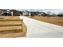View of neighborhood street with well-maintained lawns and new construction homes in a desirable community at 3154 Rosebud Rd, Loganville, GA 30052