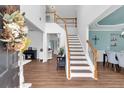 Bright foyer with hardwood floors, a staircase, and views into the dining room at 3477 Seneca Farm Dr, Buford, GA 30519