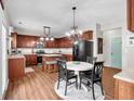 Eat-in kitchen featuring dark wood cabinets, stainless steel appliances, and a center island at 3477 Seneca Farm Dr, Buford, GA 30519
