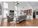 Spacious living room with a fireplace, hardwood floors, and tall windows allowing for natural light at 3477 Seneca Farm Dr, Buford, GA 30519