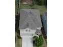 Aerial view of a two-story brick house with manicured lawn and two-car garage in a residential neighborhood at 4777 Waxwing St, Hoschton, GA 30548