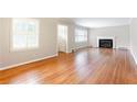 Bright living room featuring hardwood floors, a fireplace, and large windows at 2227 Leafmore Drive, Decatur, GA 30033