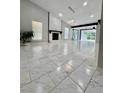 Bright living room with fireplace, white marble tile flooring, and high ceilings at 3285 Rollingbrook Way, Duluth, GA 30096