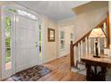 Inviting foyer features hardwood floors, paneled front door and staircase with a view to the front at 4152 Barberry Ne Dr, Roswell, GA 30075