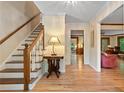 Bright foyer with hardwood floors, stairway and elegant lighting with views to other rooms at 4152 Barberry Ne Dr, Roswell, GA 30075