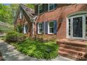 Lovely brick home with inviting front entrance, glass paned door, sidelights and brick steps with walkway at 4152 Barberry Ne Dr, Roswell, GA 30075