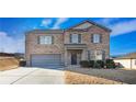 Charming two-story brick home with a gray garage door and landscaped front yard at 8484 Glenview St, Douglasville, GA 30134