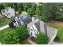 An aerial view displays manicured lawns and mature trees of a distinguished neighborhood at 1035 Eagles Brooke Dr, Locust Grove, GA 30248