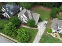 An aerial shot reveals a home's spacious lot, extended driveway and inviting curb appeal at 1035 Eagles Brooke Dr, Locust Grove, GA 30248