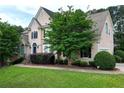 Beautiful home featuring lush landscaping, a well-manicured lawn, and traditional architectural details at 1035 Eagles Brooke Dr, Locust Grove, GA 30248